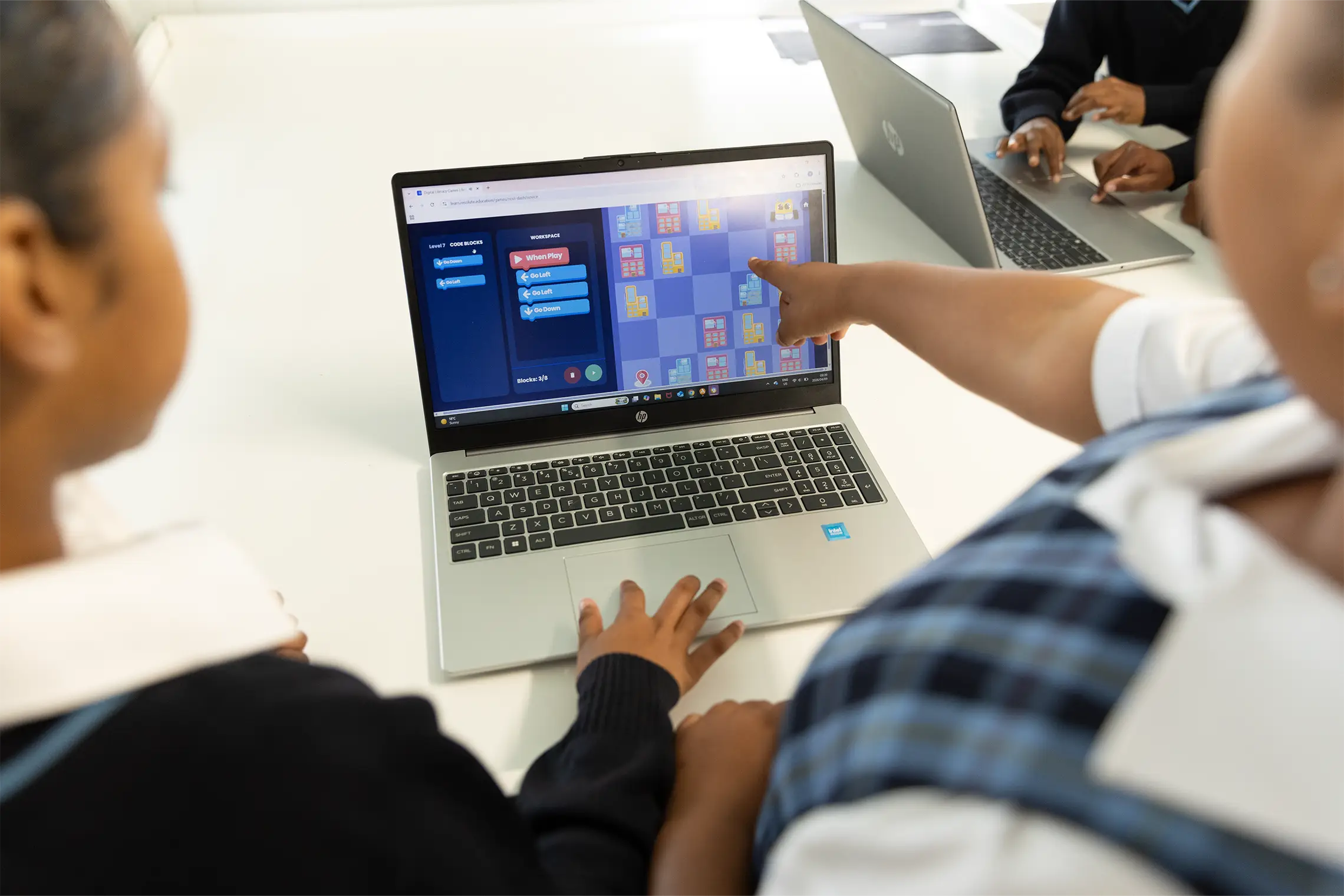 Summerhill students collaborating on a coding game